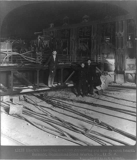 Workers operating an electric charging machine at the Homestead Steel Works in 1907